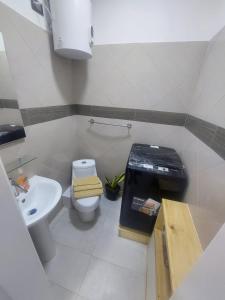 a small bathroom with a toilet and a sink at Yaque Suite in El Yaque