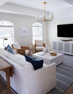 a living room with white furniture and a flat screen tv at May River Breeze in Bluffton