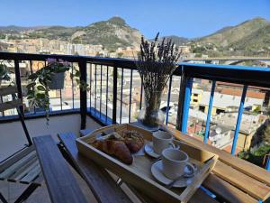 a table with coffee cups and croissants on a balcony at Genova in Genoa