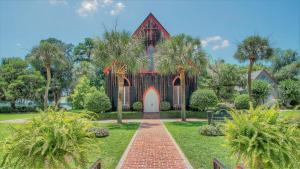 a church with palm trees in front of it at May River Breeze in Bluffton