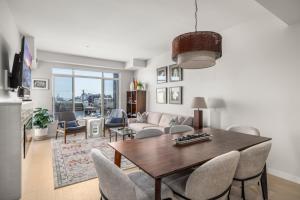 シドニーにあるModern 1000sqft+ Condo in Sidney, Ocean Views, Parking. Walk to Shops, Restaurants!のリビングルーム(木製テーブル、椅子付)