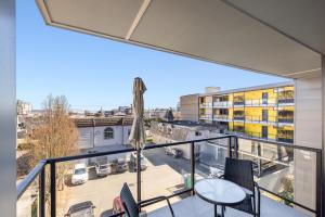 a balcony with a view of a parking lot at Modern 1000sqft+ Condo in Sidney, Ocean Views, Parking. Walk to Shops, Restaurants! in Sidney
