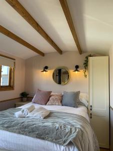 a bedroom with a large bed and a mirror at Hafod Shepherd Hut in Aberystwyth