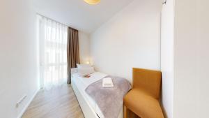a bedroom with a bed and a large window at Südkap H-02 in Pelzerhaken