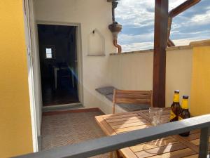 a table with two bottles on top of a balcony at Casa zia Vincenzina in Casalvecchio Siculo