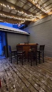 a patio with a wooden table and chairs in a room at Direct trail access/central location/Ample parking in Colebrook