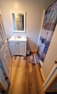 a bathroom with a sink and a mirror at Direct trail access/central location/Ample parking in Colebrook