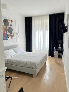 a bedroom with a bed and a desk and a window at Guicciardini 24 in Florence
