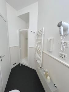 a white bathroom with a shower and a toilet at Guicciardini 24 in Florence