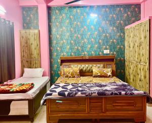 a bedroom with a bed and a wall with a wallpaper at Trilok Residency - Dashashwamedh Varanasi in Varanasi