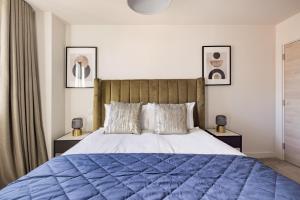 a bedroom with a large bed with a blue comforter at Charles Hope Leeds in Leeds