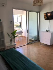 a bedroom with a large sliding glass door with a patio at Studio cabine climatisé in Sanary-sur-Mer +10 photos
