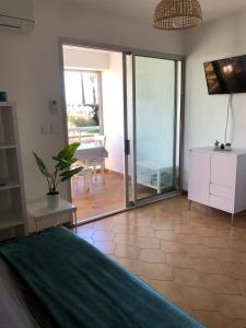 a bedroom with a large sliding glass door at Studio cabine climatisé in Sanary-sur-Mer