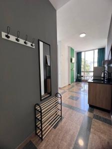 a hallway with a mirror and a staircase in a room at Cactus Apartments in Durrës