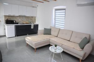 a living room with a couch and a table at Rooms Filip in Bitola