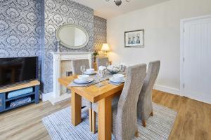 a dining room with a table and chairs and a tv at Host & Stay - Appleton House in Newark-on-Trent