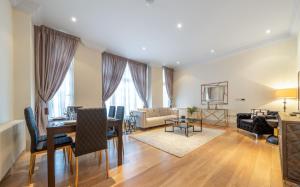 a living room with a table and a couch at Beautiful 2-Bedroom Apartment in Mayfair in London