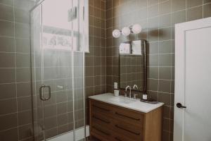 a bathroom with a sink and a mirror at The Colby House - Downtown Kingston in Kingston