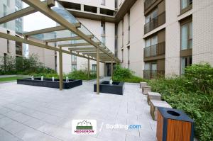 a patio in front of a tall building at Deluxe 2 Bed 2 Bath Manchester City Centre Apartment By Hedgerow Properties Limited in Manchester