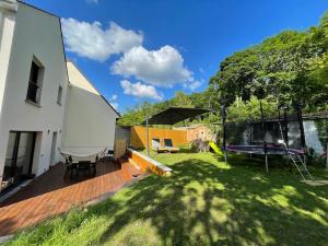 patio trasero con terraza y columpio en Maison moderne et confortable en bordure de forêt, en Poissy