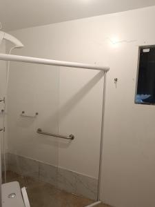 a glass shower in a bathroom with a toilet at Chalé Beija Flor in Porto Belo