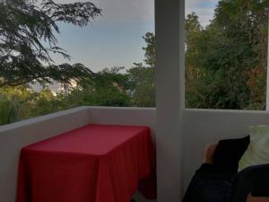 a table with a red table cloth on a balcony at Loft Vista Mar en Puerto Ángel in Puerto Ángel