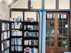 a room with two book shelves filled with books at Le chalet de Blonville in Blonville-sur-Mer