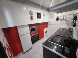 a small kitchen with a sink and a stove at Los Gigantes,huge terrace,sea view,air conditioning in Puerto de Santiago