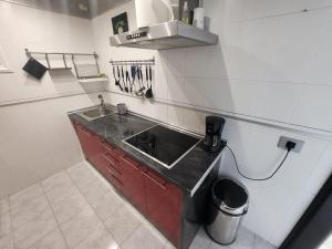 a kitchen with a sink and a counter top at Los Gigantes,huge terrace,sea view,air conditioning in Puerto de Santiago