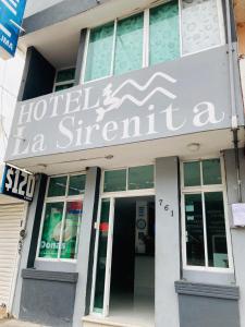 a building with a sign on the front of it at La Sirenita in Veracruz