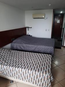 Кровать или кровати в номере Flat no Sol Vitória Marina 2