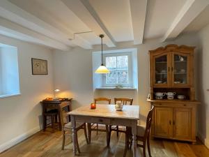 a dining room with a table and chairs at Cherrytree Cottage 1840 in Heimbach