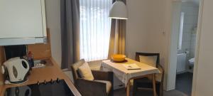 a small room with a table and chairs and a kitchen at Ferienhaus Pauls Ferienhaus Pauls, Whg 10 in Norderney