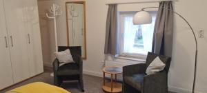 a living room with two chairs and a window at Ferienhaus Pauls Ferienhaus Pauls, Whg 10 in Norderney
