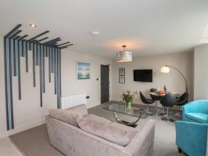 a living room with a couch and a table at Apt 5 Hunter's Quay in Bridlington