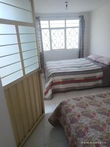 a bedroom with a bed and a window at hermoso departamento un lugar para descansar 2 in Tlaxcala de Xicohténcatl