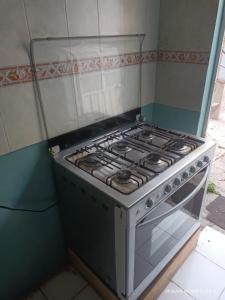 a stove in the corner of a kitchen at hermoso departamento un lugar para descansar 2 in Tlaxcala de Xicohténcatl