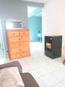 a kitchen with a black refrigerator and a dresser at hermoso departamento un lugar para descansar 2 in Tlaxcala de Xicohténcatl