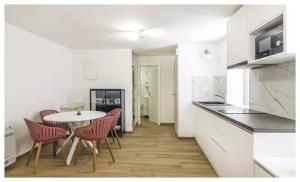 a kitchen with a table and chairs and a kitchen with white counters at House Gambin in Primošten