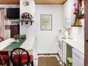 a small kitchen with a counter and a table at Holiday Home Aurinkoalppi 12b paritalo by Interhome in Hyrynsalmi