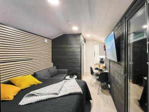 a bedroom with a bed and a couch and a desk at Holiday Home Rakkaranta c- henry ford cabin two skipa by Interhome in Hyrynsalmi