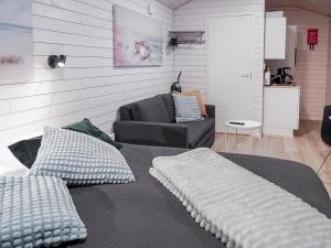 sypialnia z łóżkiem, kanapą i krzesłem w obiekcie Holiday Home Rakkaranta d- beach house by Interhome w mieście Hyrynsalmi