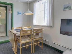 a dining room with a table and chairs and a tv at Apartment Withar - all inclusive - 800m from the sea by Interhome in Fanø