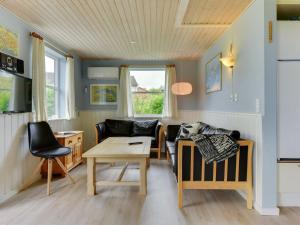 a living room with a couch and a table at Holiday Home Venla - all inclusive - 150m from the sea by Interhome in Augustenborg