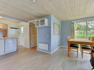 a kitchen and dining room with a wooden ceiling at Holiday Home Venla - all inclusive - 150m from the sea by Interhome in Augustenborg