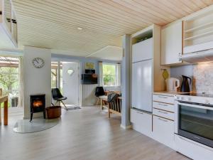 a kitchen and living room with a fireplace at Holiday Home Venla - all inclusive - 150m from the sea by Interhome in Augustenborg