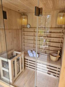 a sauna with a glass shower and a dog in it at Holiday Home David in Slunj