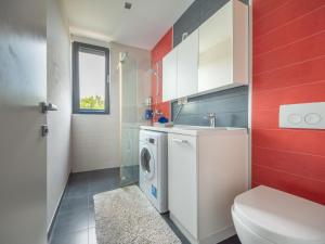 een badkamer met een wasmachine en een wastafel bij Apartment Oliva 2 by Interhome in Kostrena