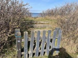 a wooden fence on the side of a beach at Apartment Niesina - all inclusive - 35m from the sea by Interhome in Hundested