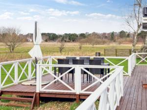 een terras met een tafel en stoelen en een parasol bij Holiday Home Franka - all inclusive - 250m from the sea by Interhome in Klint